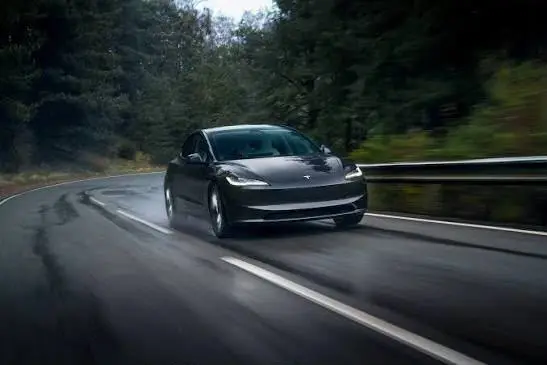 Donkere Tesla Model 3 op een landweg